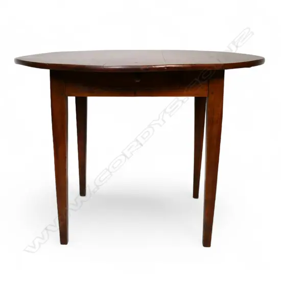 A French c.1900 fruitwood circular kitchen table,